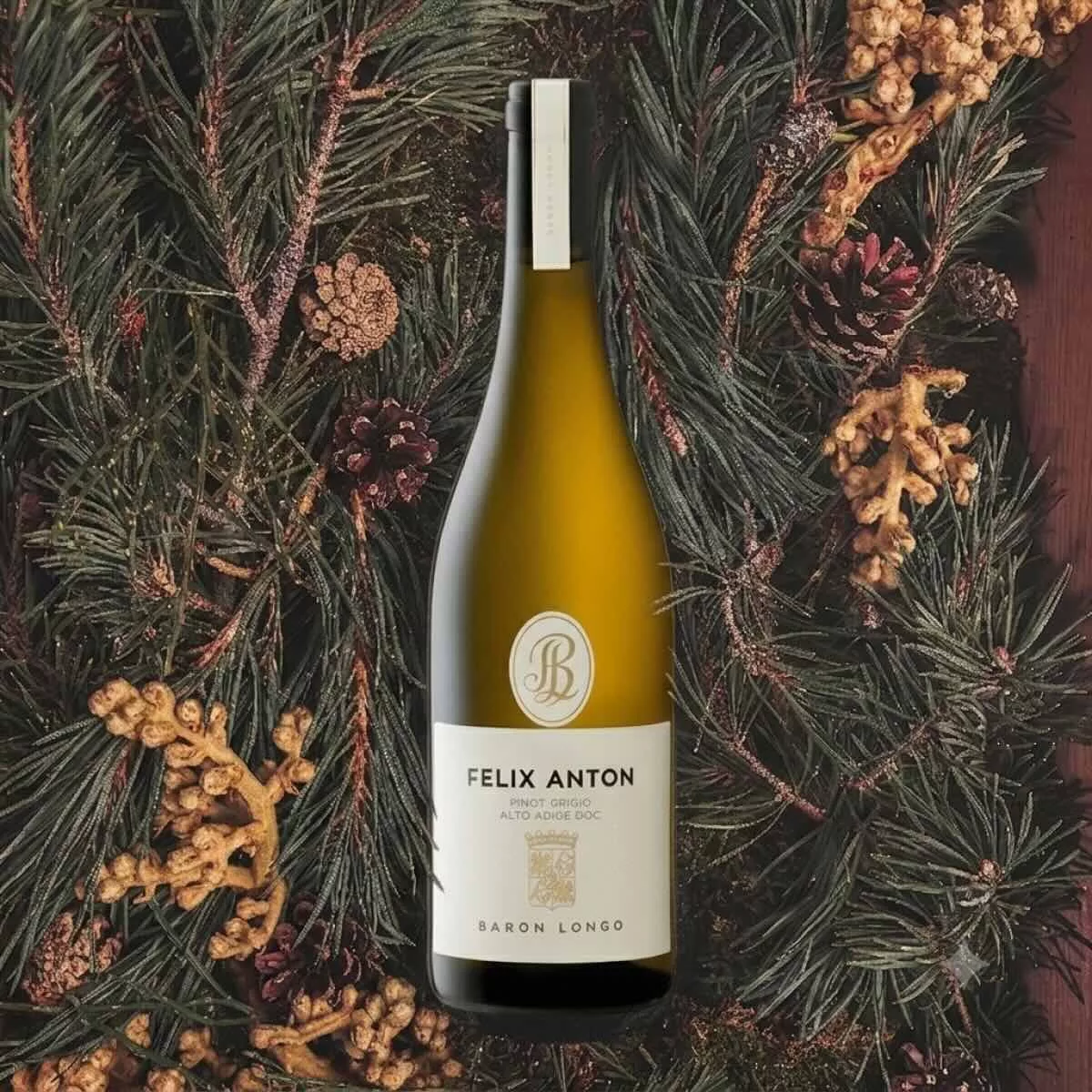 Baron Longo Felix Anton Pinot Grigio Alto Adige DOC fles tegen een achtergrond van dennentakken en dennenappels